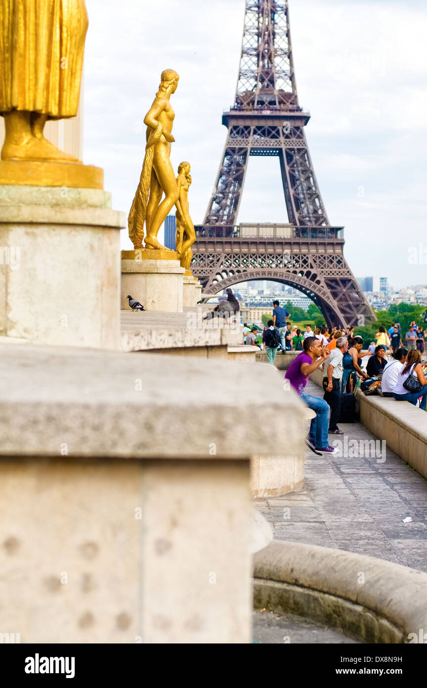 Paris, France - August 2, 2011: The Eiffel Tower is viewed from the Place of the Trocadero with the focus on the gold statue. Stock Photo