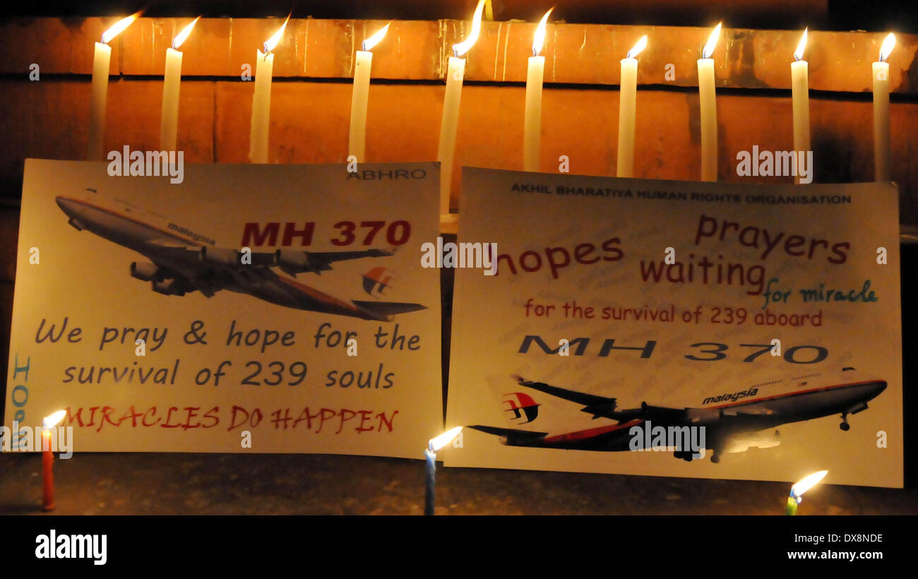 Amritsar, India - 20th March 2014: Members of Akhil Bharatiya Human Rights Organisation holding a candle light vigil for the safety of the passengers of the missing Malaysian plane, in Amritsar on Thursday. The missing aircraft disappeared one week ago carrying 227 passengers and 12 crew, baffling the international rescue and search teams who have found no remains or clues in the waters surrounding South East Asia. All passengers and crew are currently under investigation for possible sabotage although no evidence of such activity has been found. (Photo by Prabhjot Gill/Pacific Press) Stock Photo