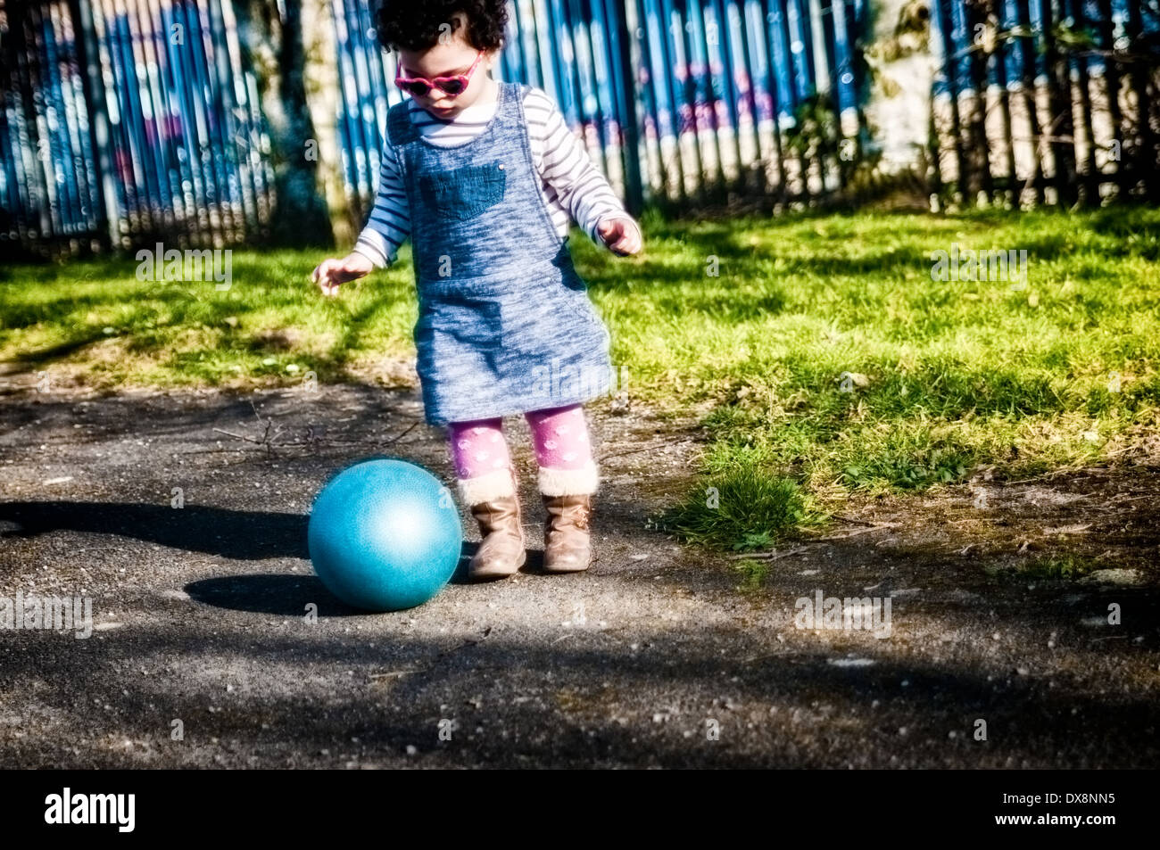 Toddler, 2-3 years old, is playing with Plastic Ball in Park Stock Photo