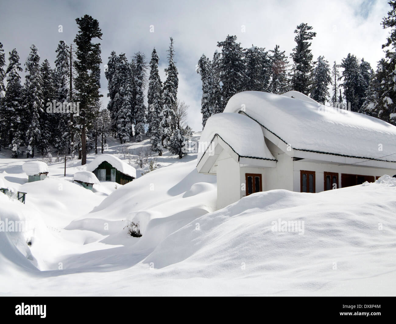 India, Kashmir, Gulmarg, Himalayan Ski Resort, houses almost buried in heavy snowfall Stock Photo