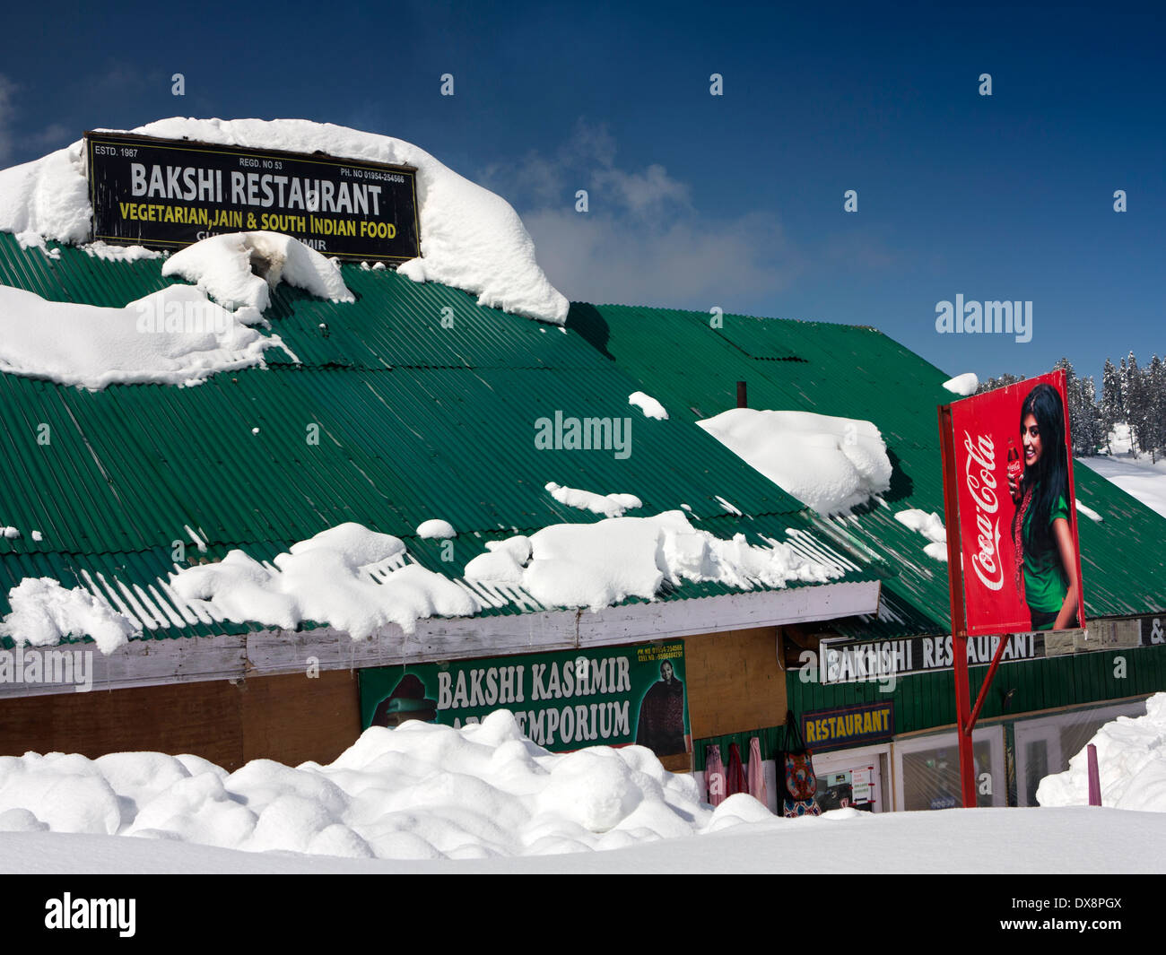 India, Kashmir, Gulmarg, Himalayan Ski Resort, snow covered Bakshi Restaurant and Kashmir Arts Emporium Stock Photo