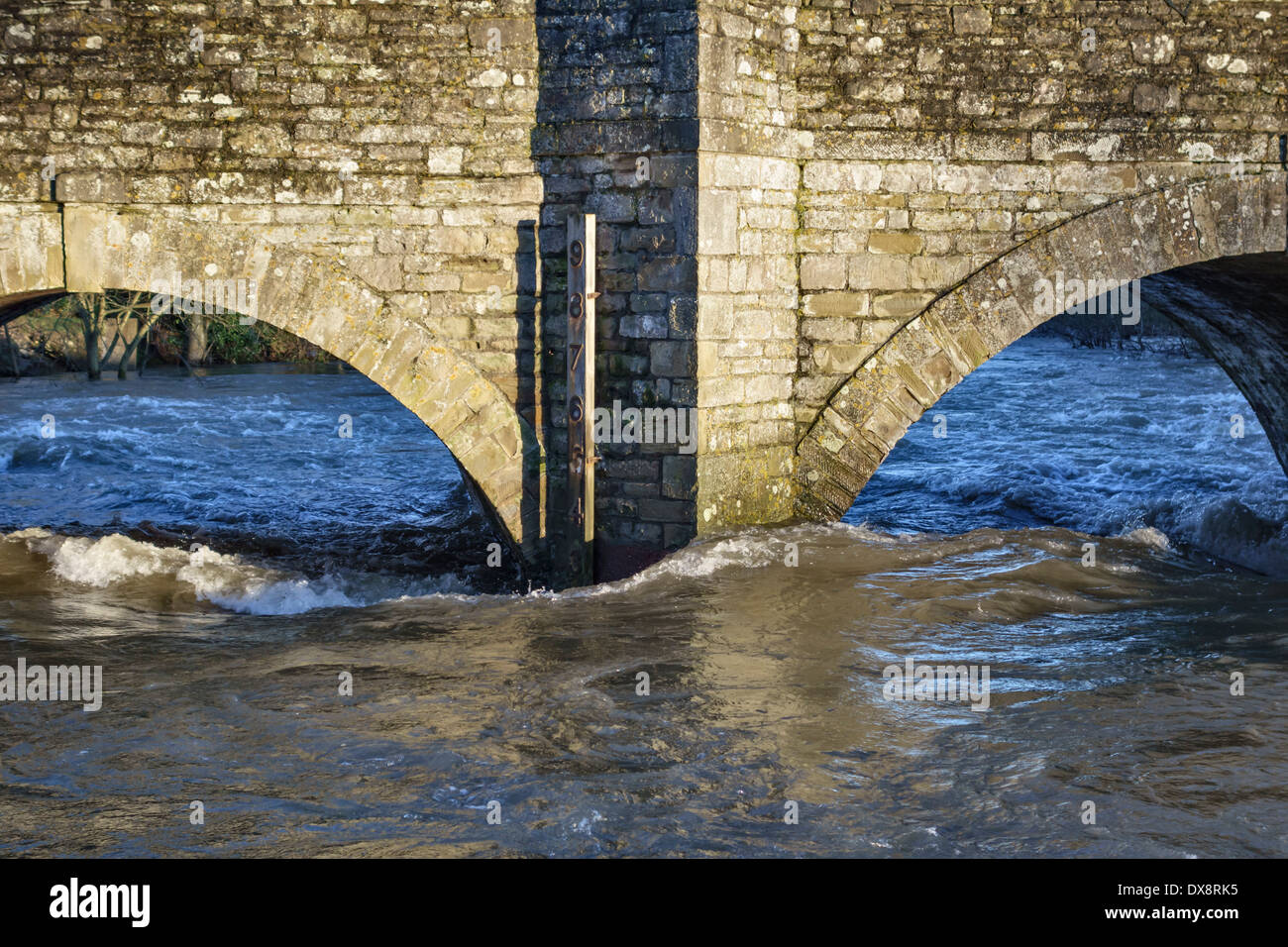 The depth gauge on the medieval bridge across the flooded River Teme at