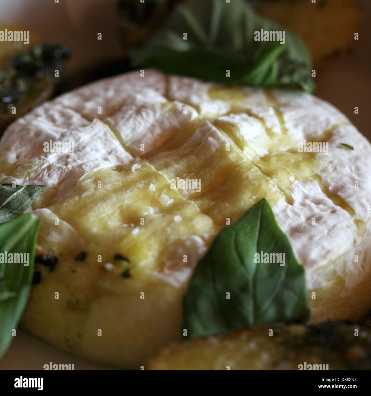Baked Camembert cheese served with roast potatoes in Villars, Switzerland. Stock Photo