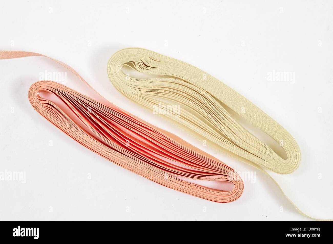 Yellow and orange ribbons on white background with copy space Stock