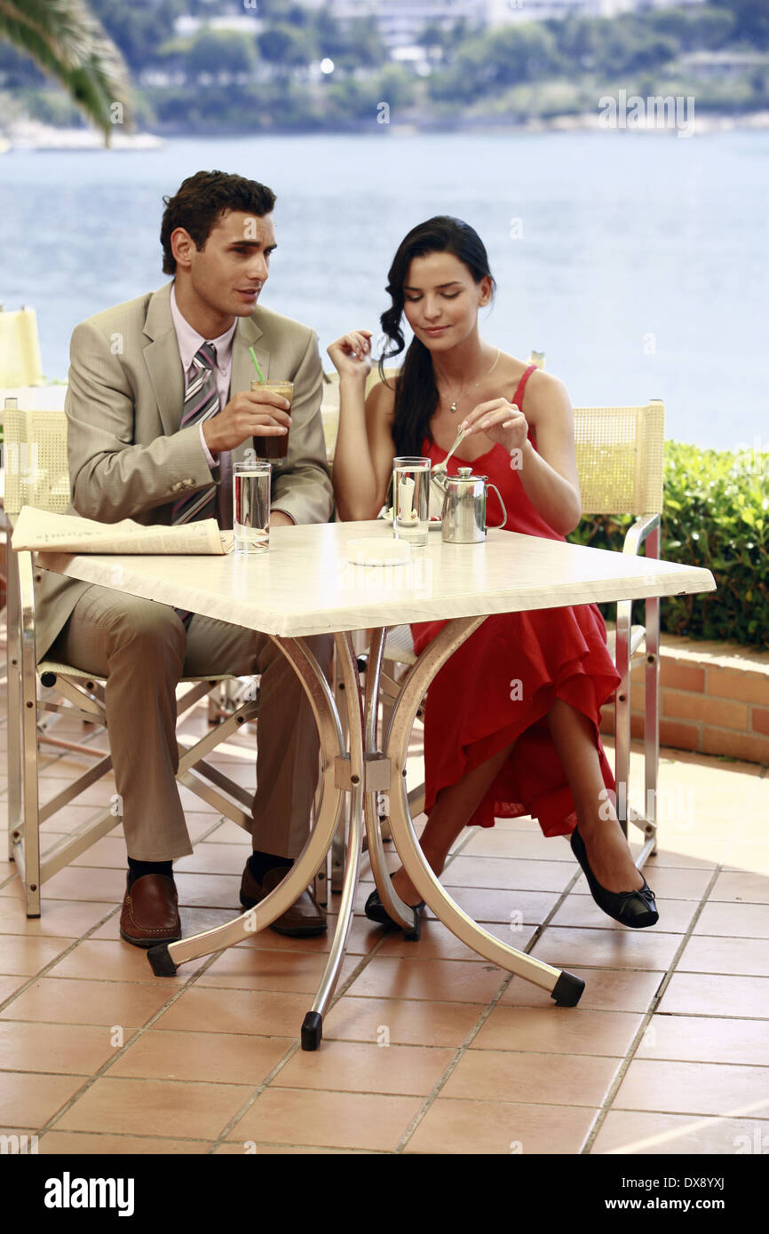 Couple at seaside cafe table Stock Photo