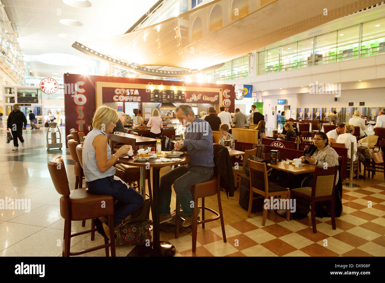 People drinking coffee at Costa Coffee, Dubai Airport, Dubai, UAE