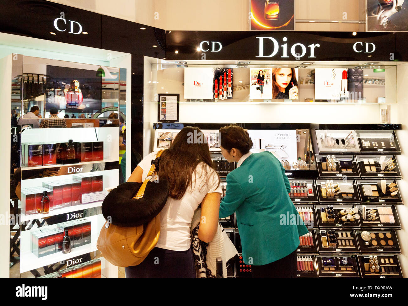 Woman buying Dior cosmetics, Duty Free shop, Dubai airport departure lounge, UAE, United Arab Emirates Middle East Stock Photo