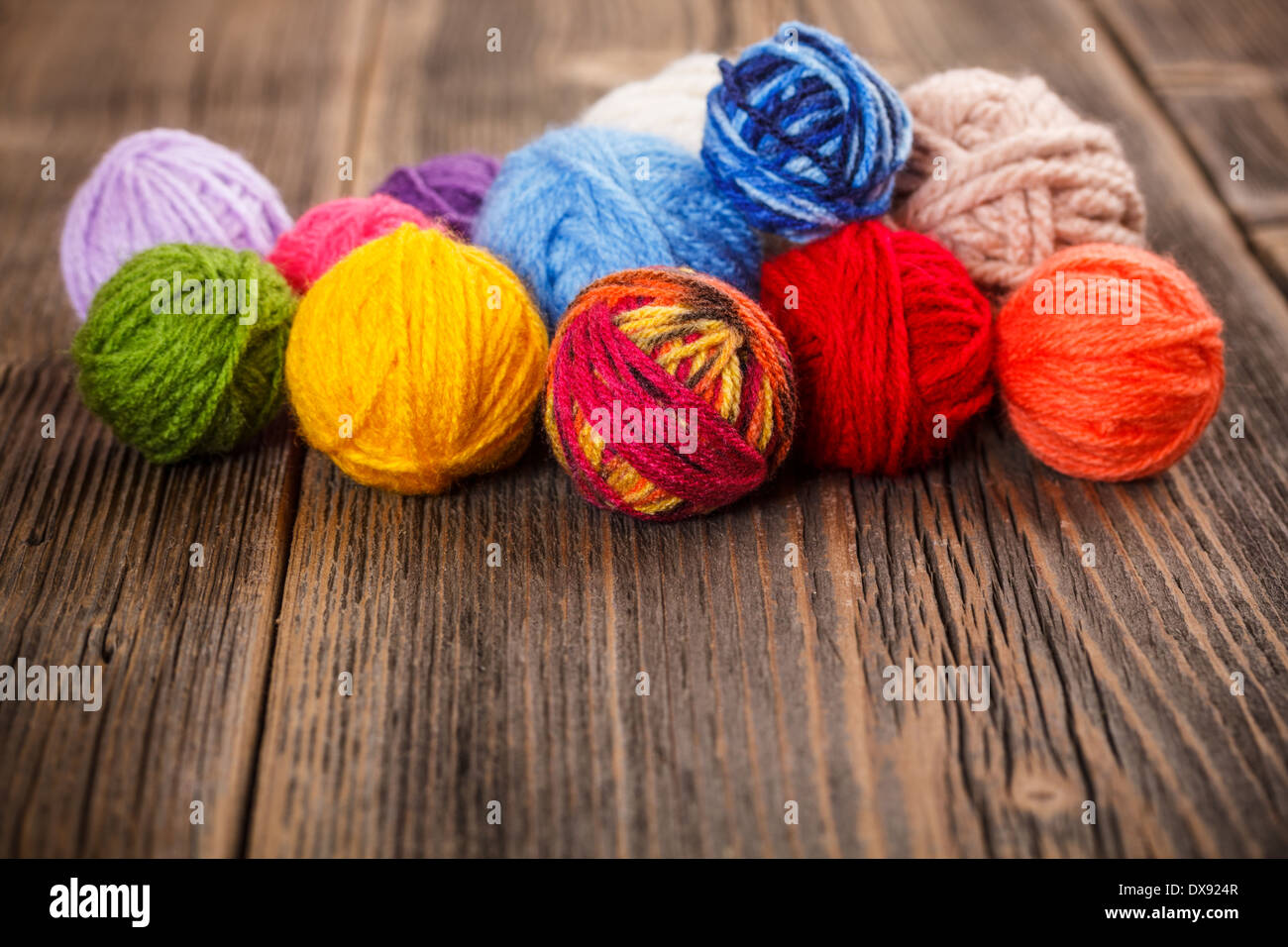 Knitting yarn on rustic wooden background Stock Photo - Alamy