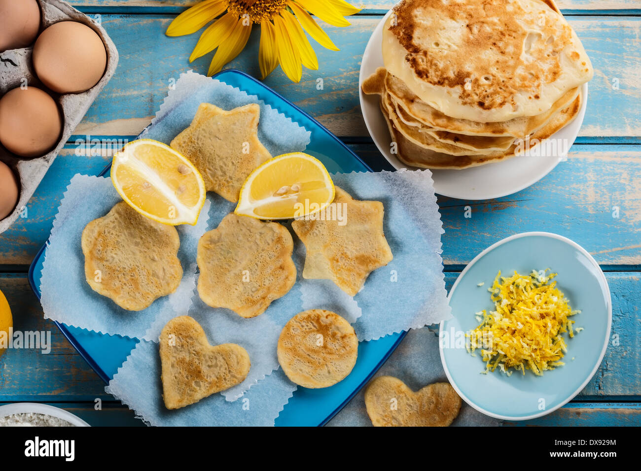 Various shaped lemon pancakes on a blue plate Stock Photo