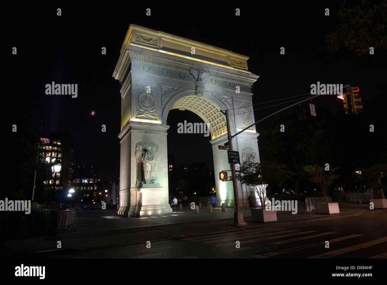 Looking South at the Washington Square Arch illuminated at night seen from the corner of 4th St & 5th Ave in Greenwich Village Stock Photo