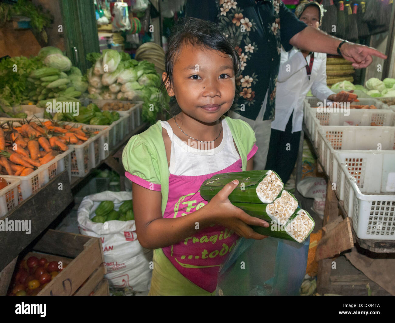 Young girl buying food at the market, Bengkulu, Southwest Sumatra, Indonesia Stock Photo
