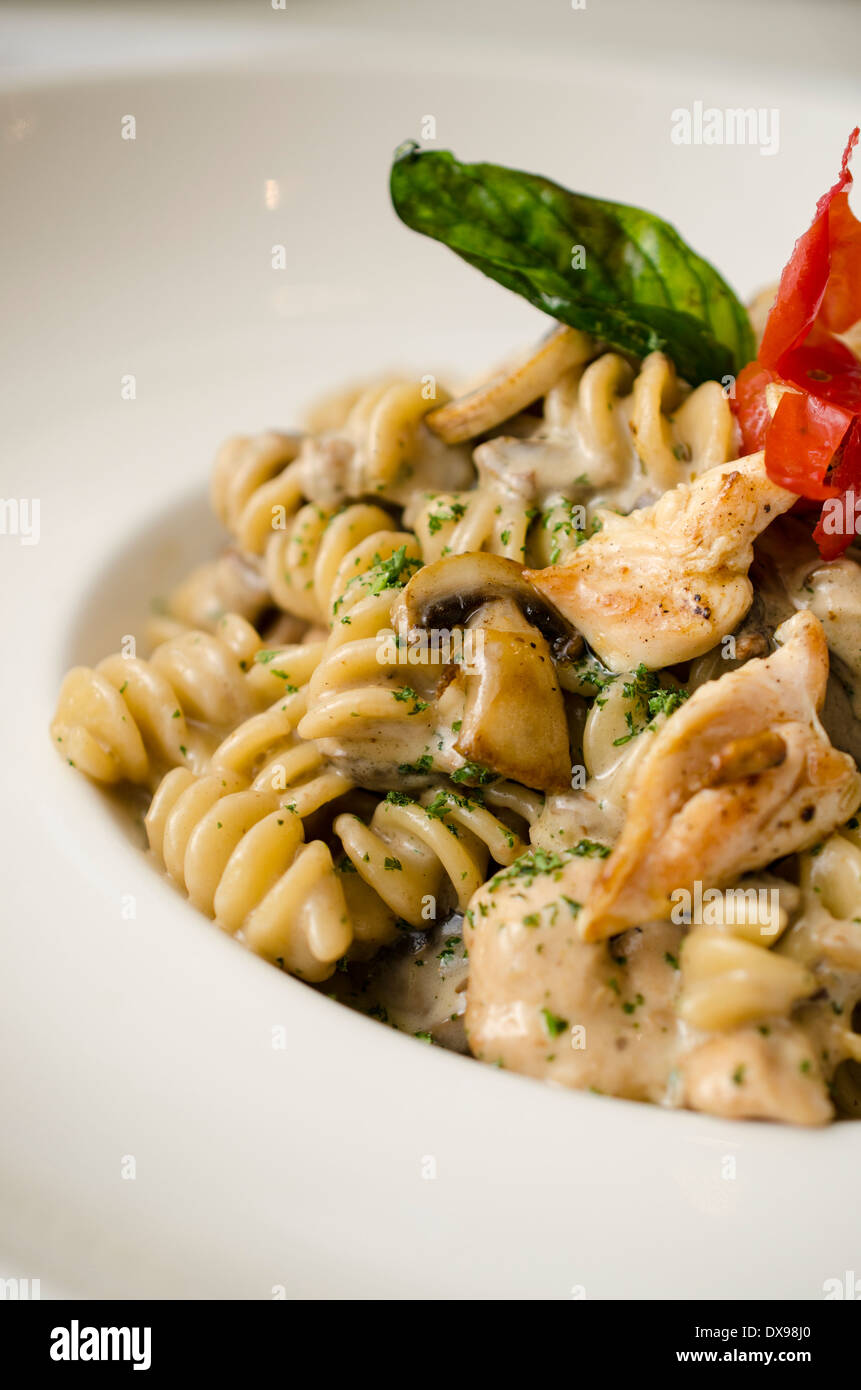 Fusilli (pasta) cooked al dente, in a creamy sauce with mushrooms and