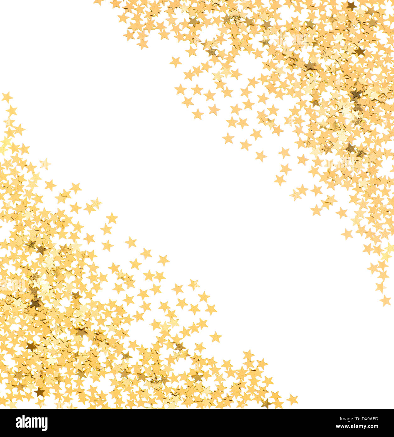 star shaped golden confetti on white background. festive background Stock Photo