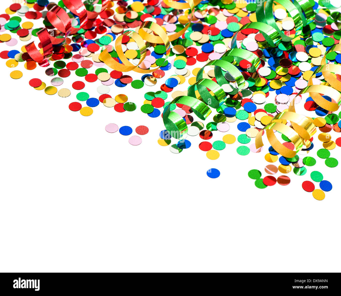 colorful party decoration with confetti and shiny streamer over white background Stock Photo