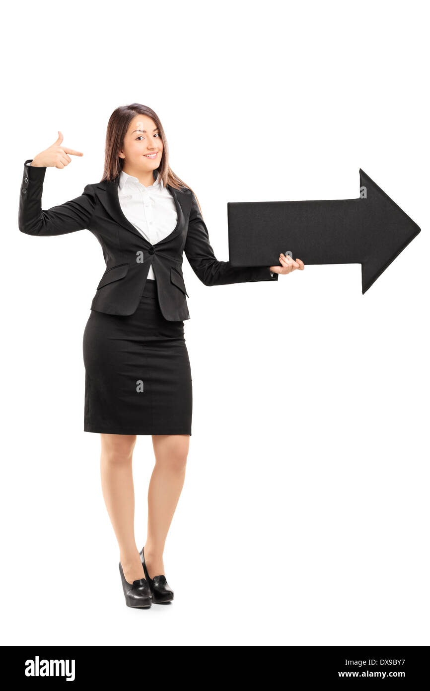 Businesswoman holding a big black arrow pointing right Stock Photo - Alamy