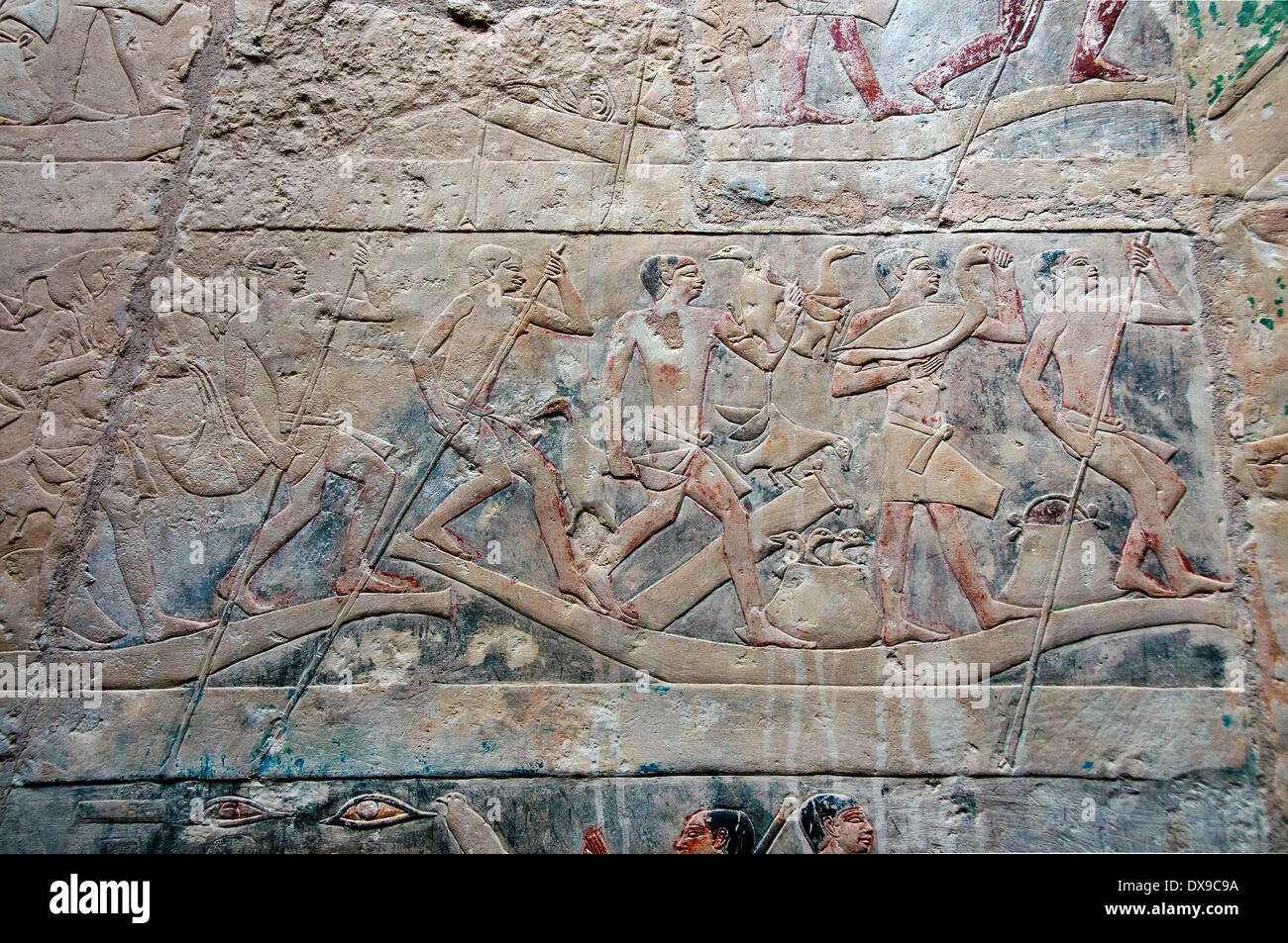 Relief in mastaba Kagemni in Saqqara necropolis: men carrying goods on the Nile Stock Photo