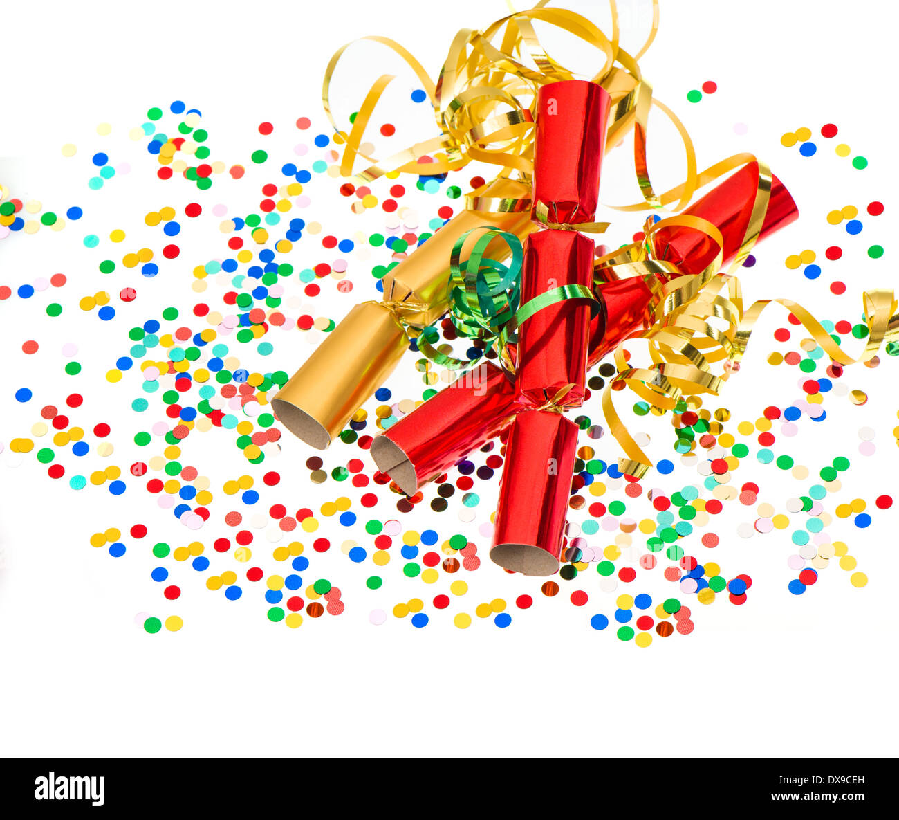 party cracker, golden streamer and confetti over white. festive decoration background Stock Photo