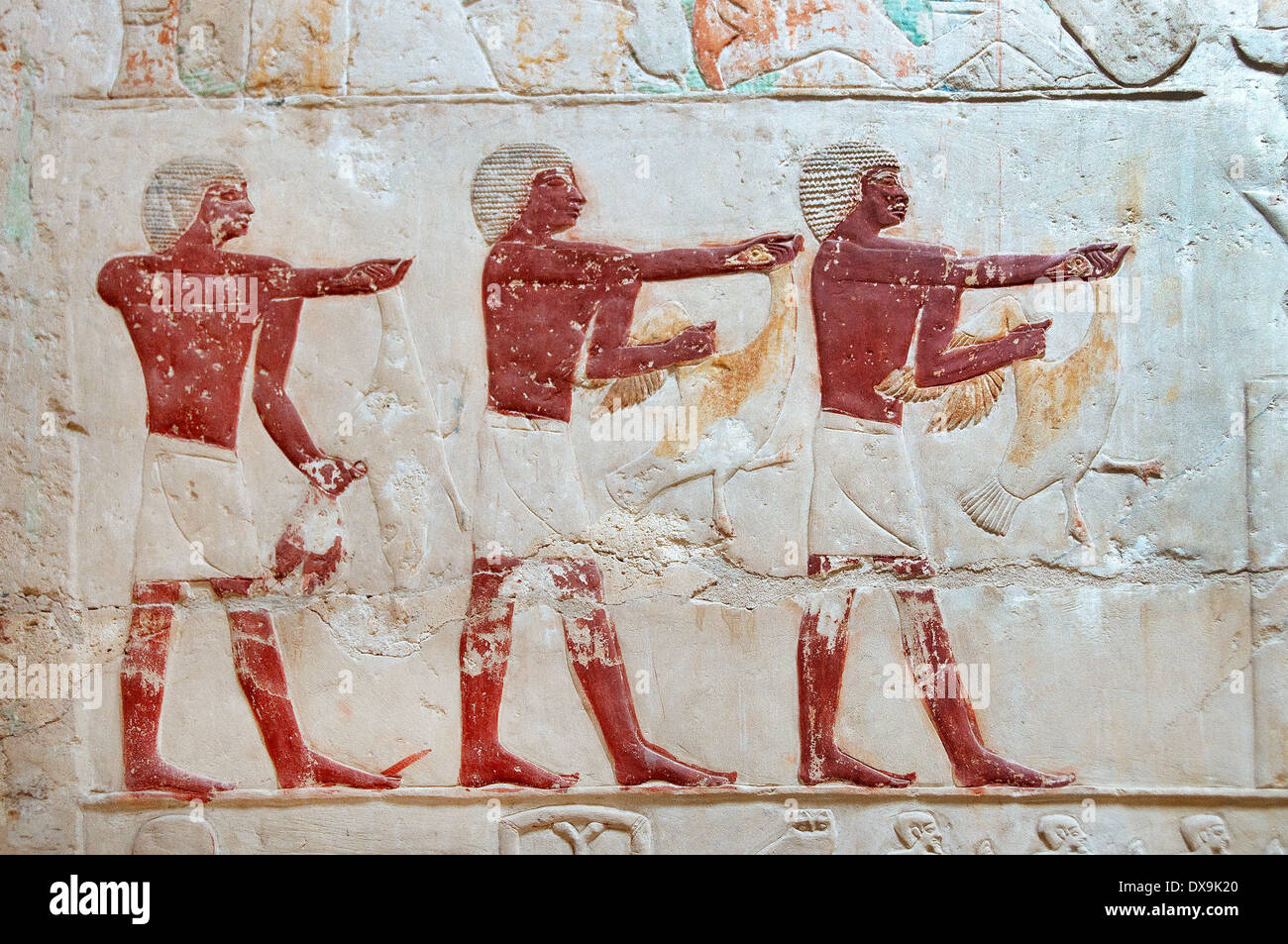 Relief in mastaba Kagemni in Saqqara, Egypt: three men with geese Stock Photo