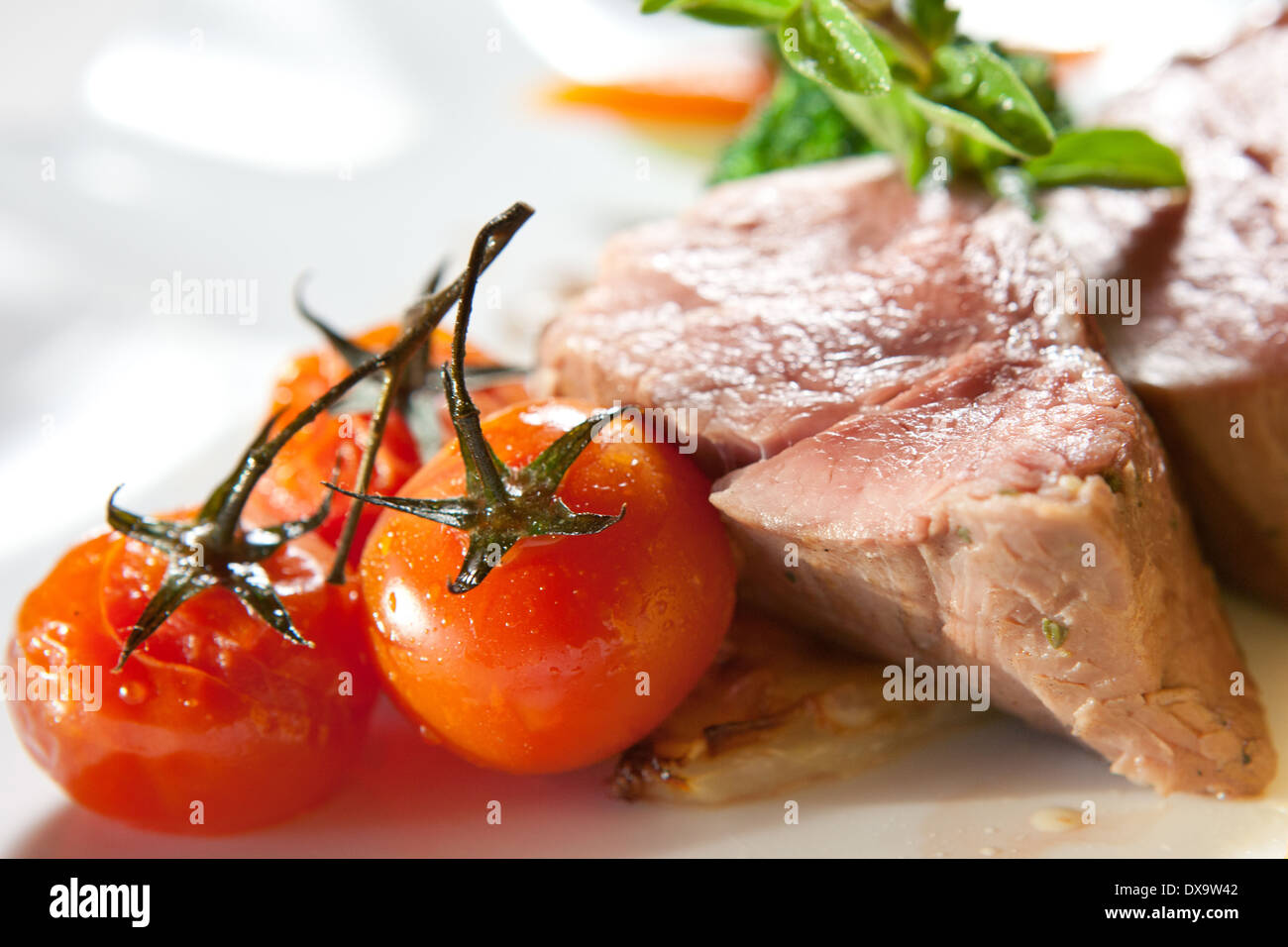 pork with tomatoes, turnips, rosemary, zucchini and vinegar Stock Photo