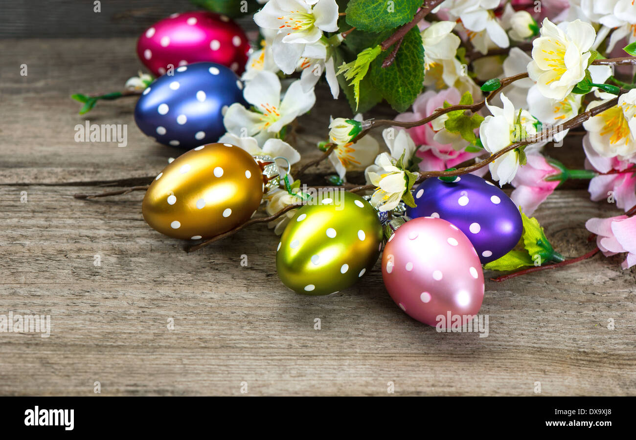 spring flowers and easter eggs decoration on rustic wooden background Stock Photo