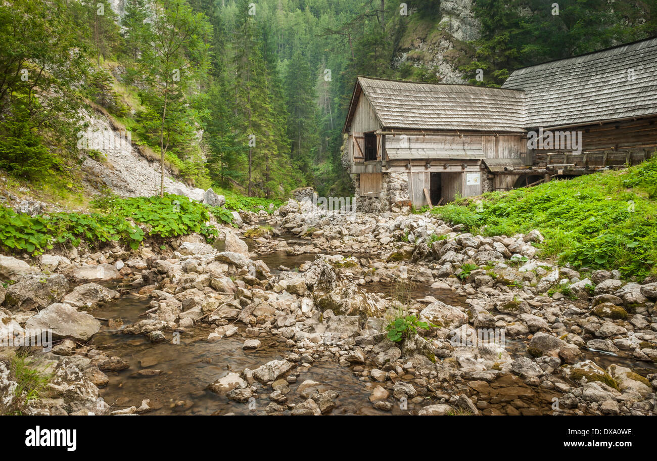 wooden cottage in the mountains with creek and grass Stock Photo - Alamy