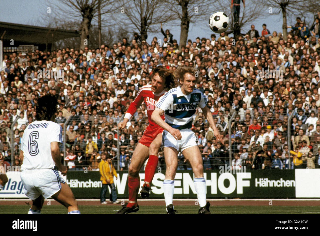 football, Bundesliga, 1981/1982, Wedau Stadium, MSV Duisburg versus Borussia Moenchengladbach 0:1, scene of the match, aerial duel, Kurt Pinkall (MG) left and Frank Saborowski (MSV) Stock Photo