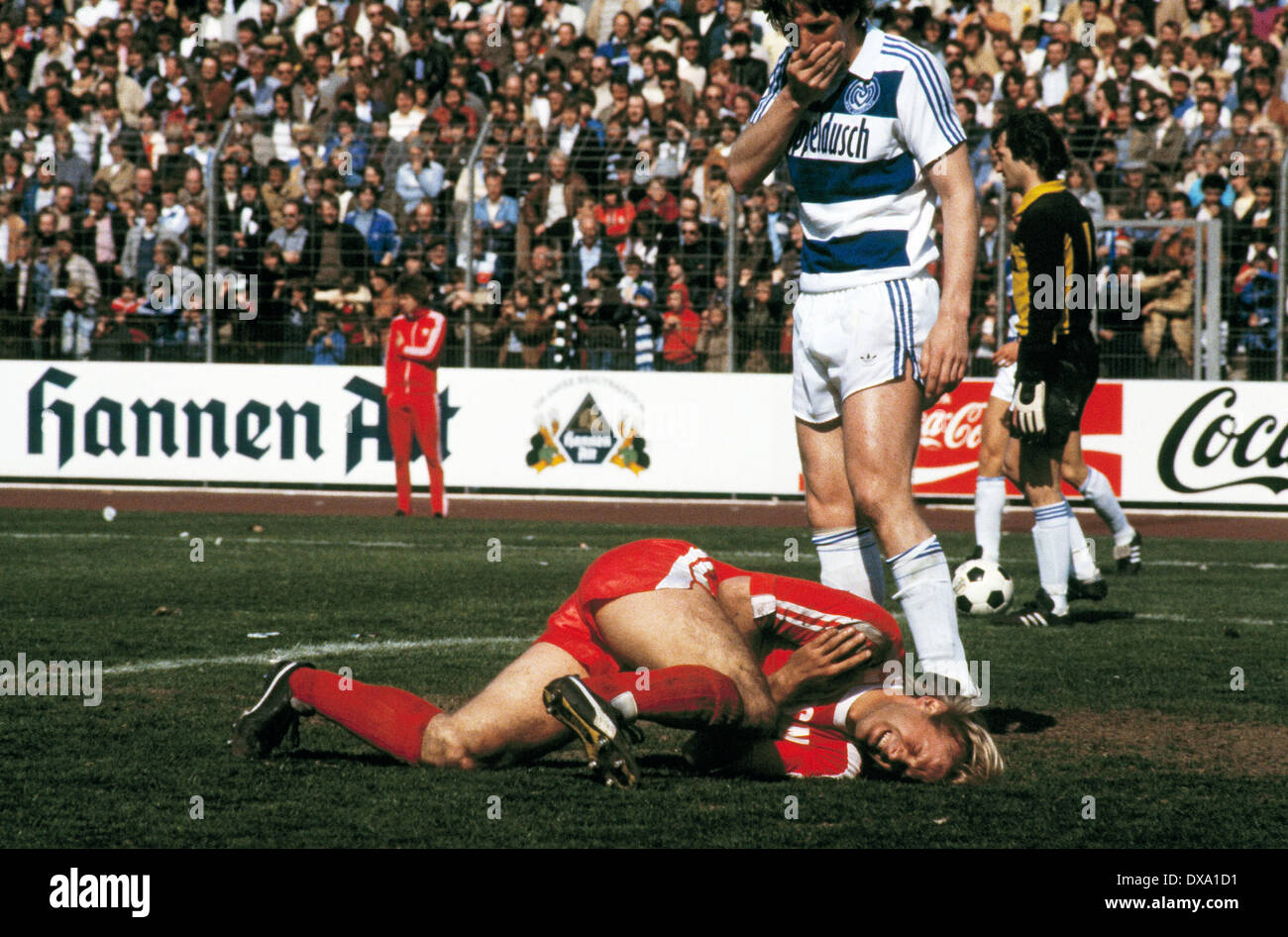 football, Bundesliga, 1981/1982, Wedau Stadium, MSV Duisburg versus Borussia Moenchengladbach 0:1, scene of the match, Hans-Guenter Bruns (MG) lying injured aground, a Duisburg player is horrified Stock Photo