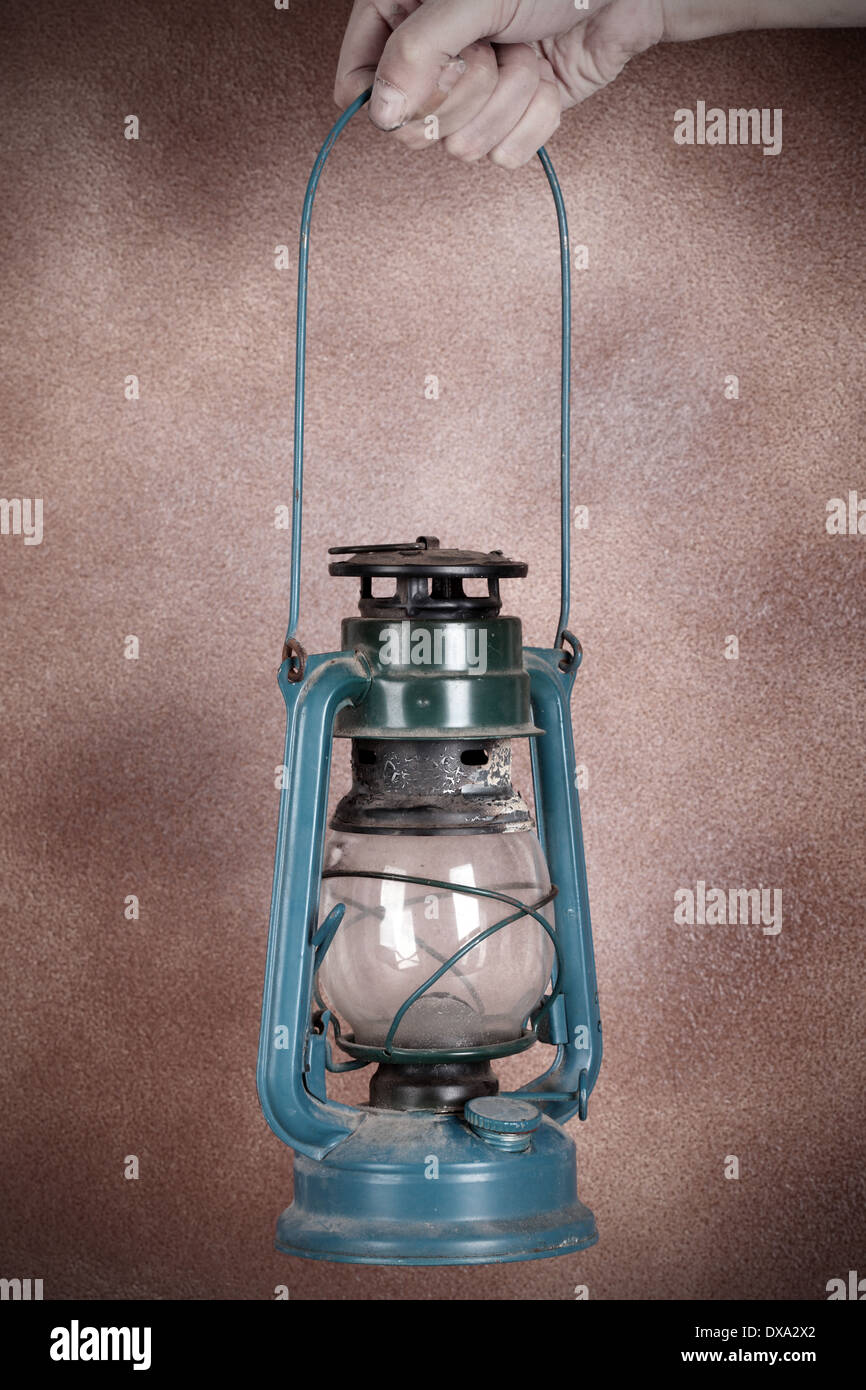 https://c8.alamy.com/comp/DXA2X2/old-rusty-kerosene-lamp-on-a-human-hand-DXA2X2.jpg