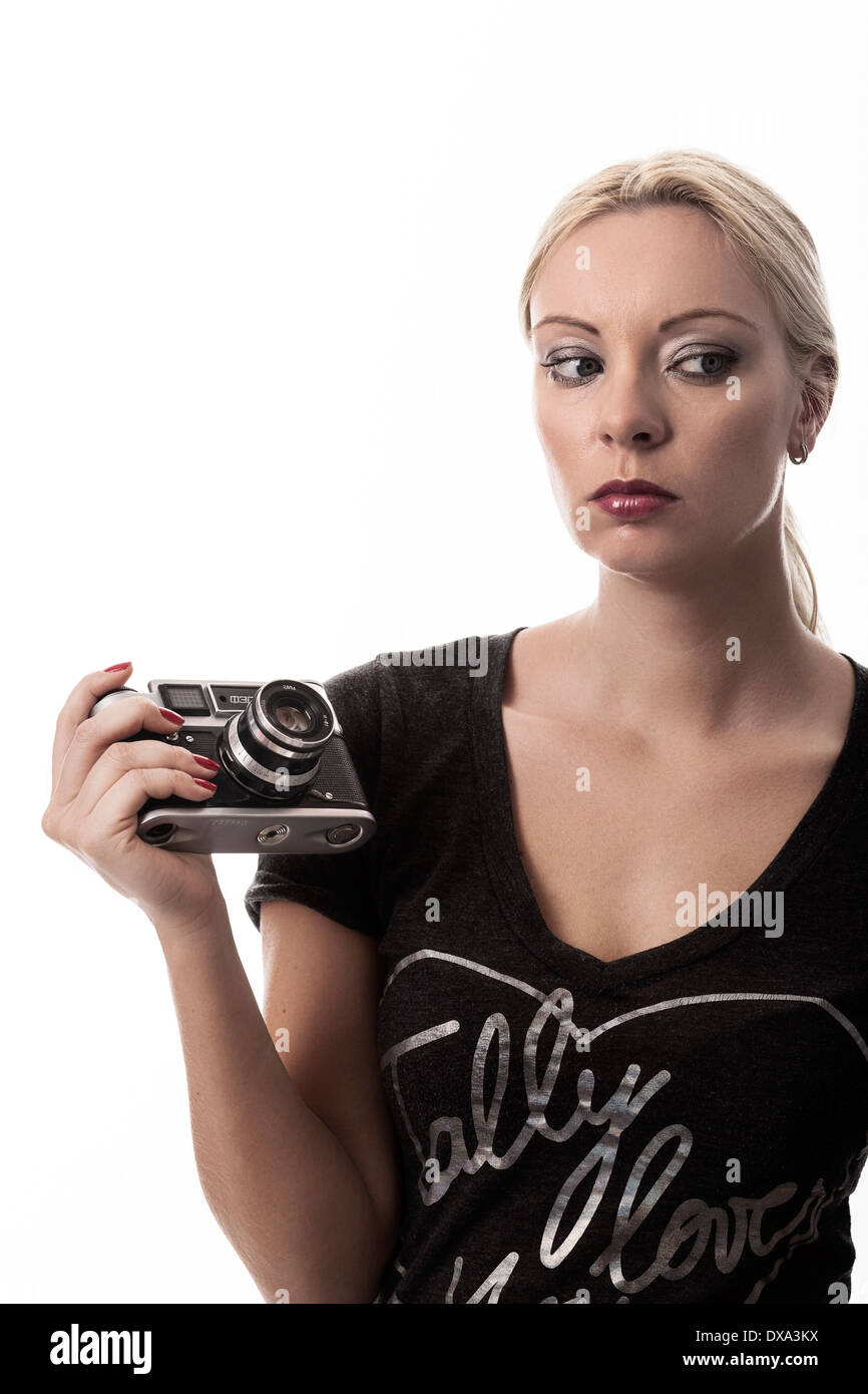 Attractive blonde woman holding old fashioned russian fed camera. Stock Photo