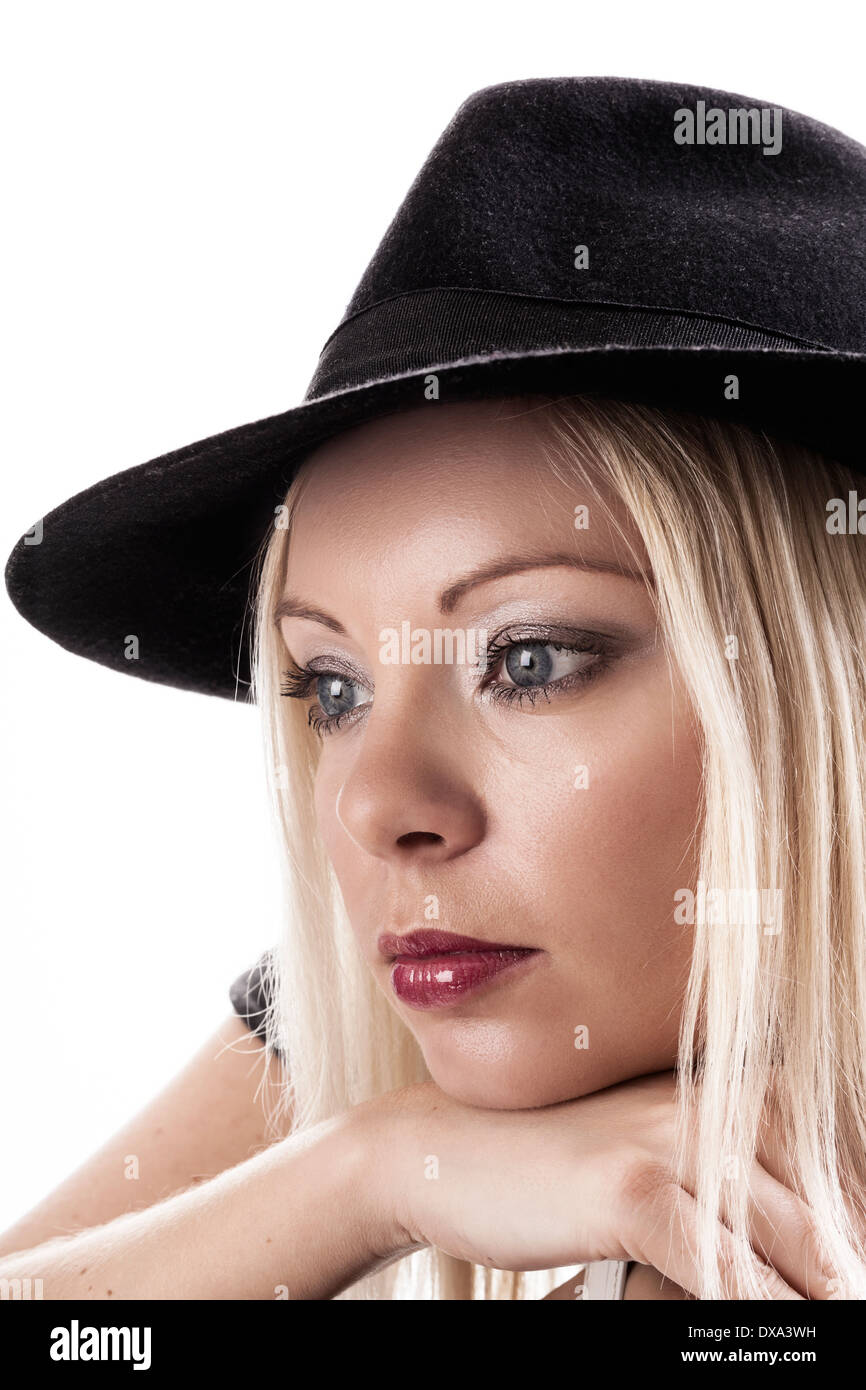 Attractive twenty something woman wearing black hat looking thoughtful. Stock Photo