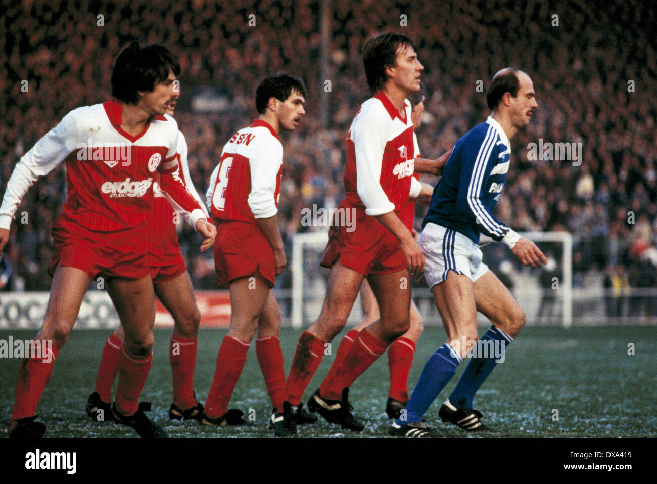 football, 2. Bundesliga, 1983/1984, Georg Melches Stadium, Rot Weiss Essen versus FC Schalke 04 1:1, scene of the match, Manfred Drexler (S04) right against three RWE opposing players Stock Photo