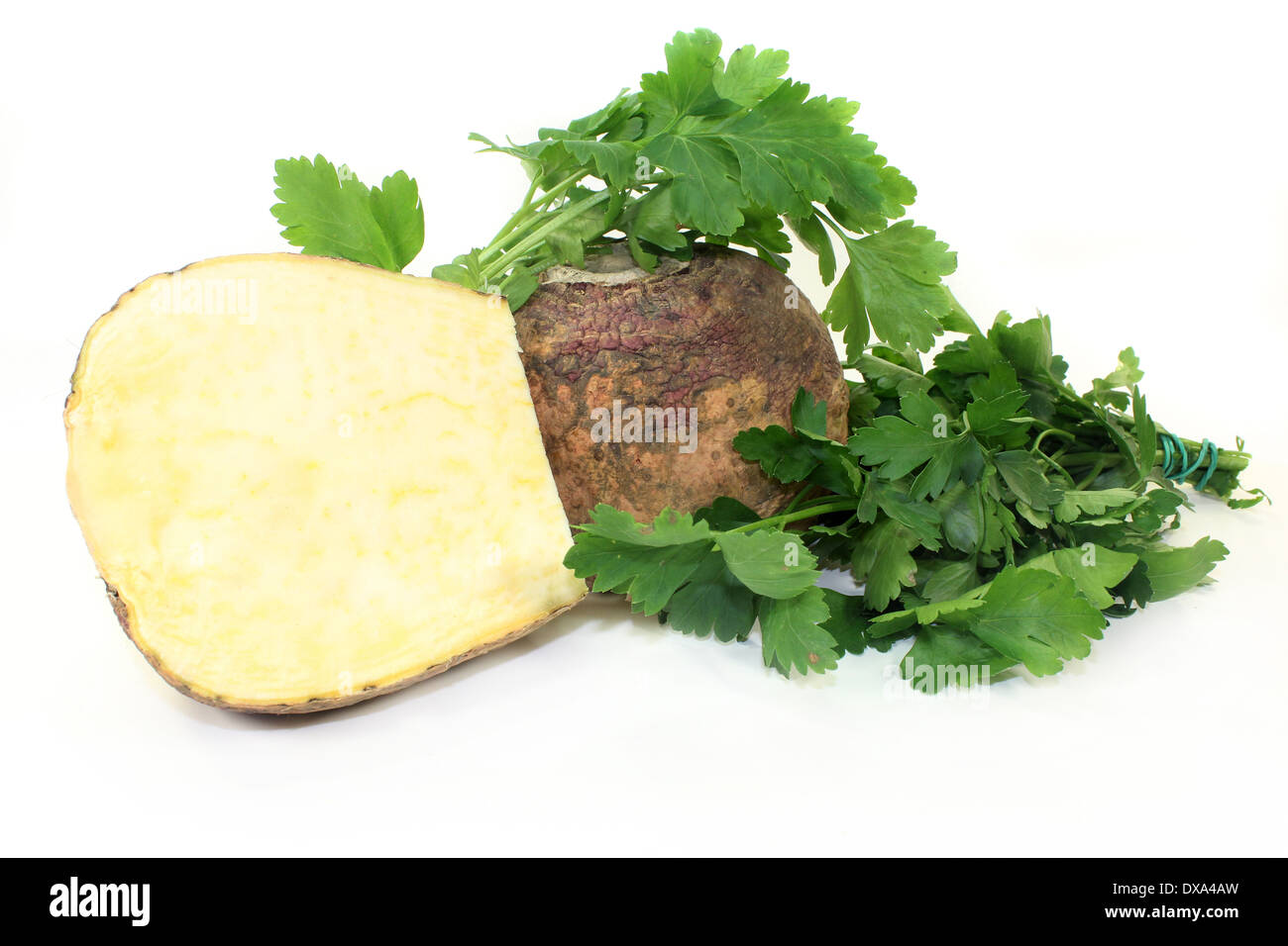 two turnips and parsley against white background Stock Photo
