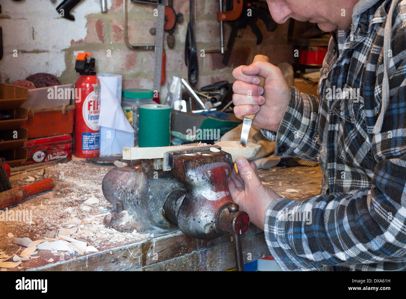Spoon Carver Using a Crook Knife to Carve out the Bowl Stock Photo