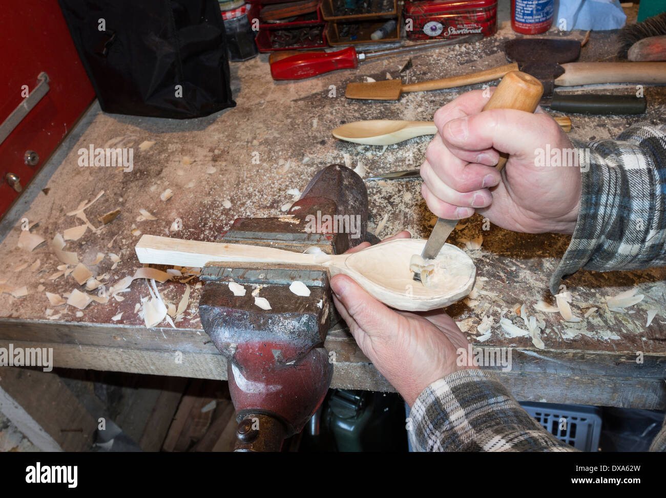 Spoon Carver Using a Crook Knife to Carve out the Bowl Stock Photo