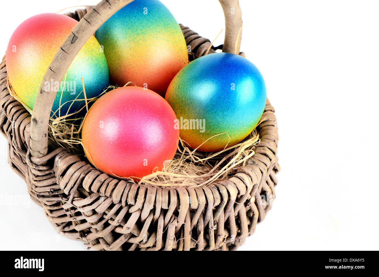 Colorful painted easter eggs in brown basket in white Stock Photo - Alamy