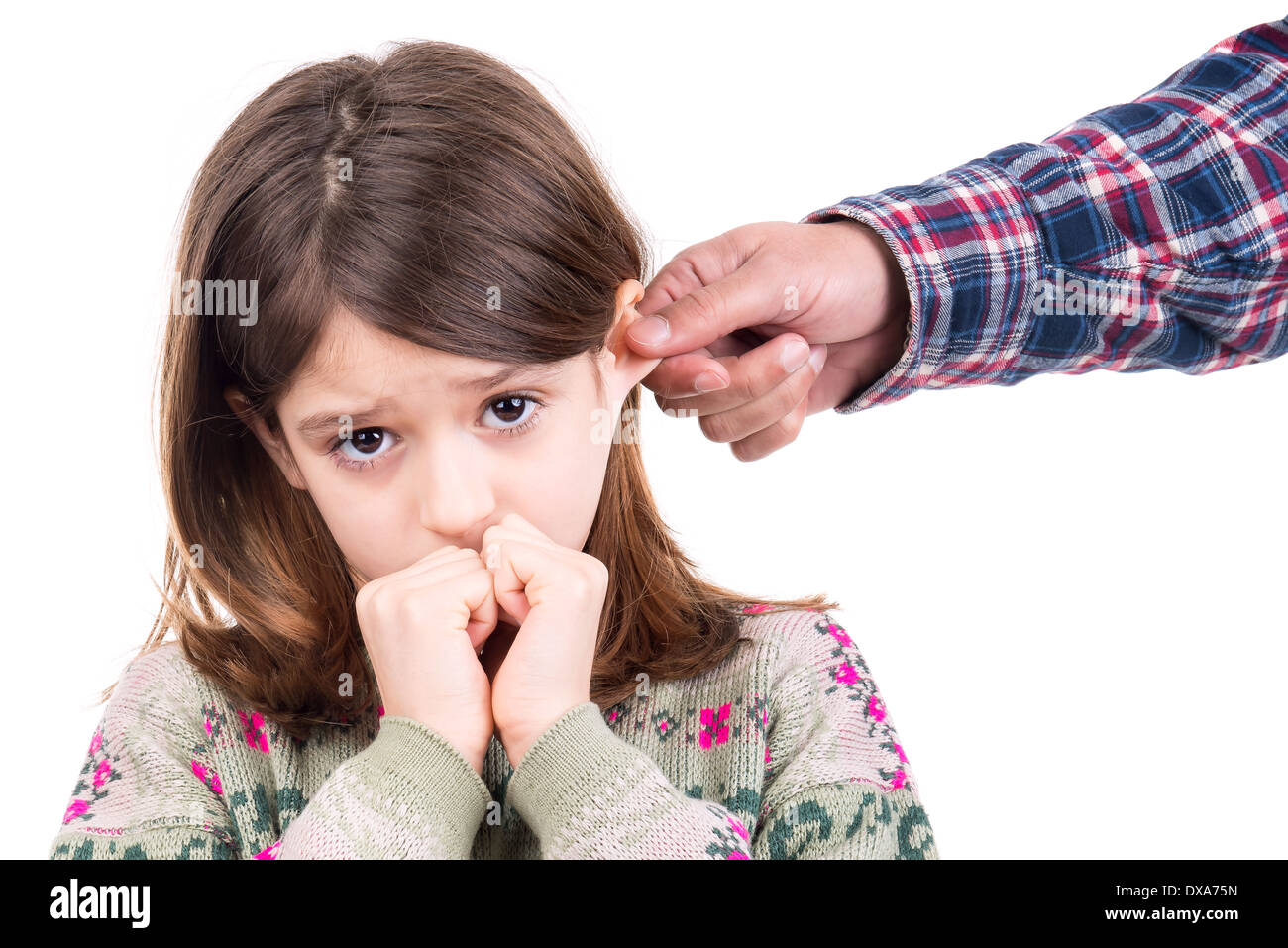 Young girl being punished with ear pulling Stock Photo Alamy