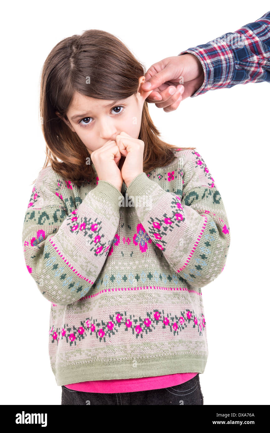 Young girl being punished with ear pulling Stock Photo