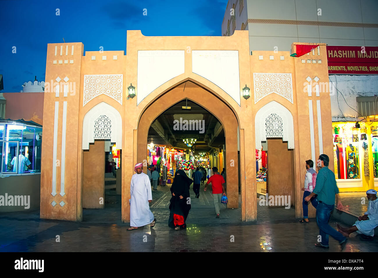 Unidentified people in front of the entrance into the souk market in Muscat, Oman Stock Photo