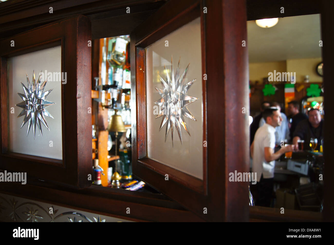 Interior of an English pub, Travellers Friend, ('The Spivs'), Woodford Green, Essex, England showing snob screens Stock Photo