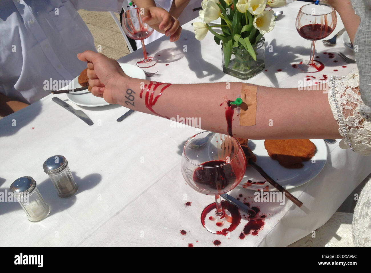 Activists from 269life animal rights movement take part in a visual protest whereby they draw their own blood to emphasize their ideology in Tel Aviv on 21 March 2014. 269life was founded to draw attention to the plight of animals raised and slaughtered for human consumption. Stock Photo