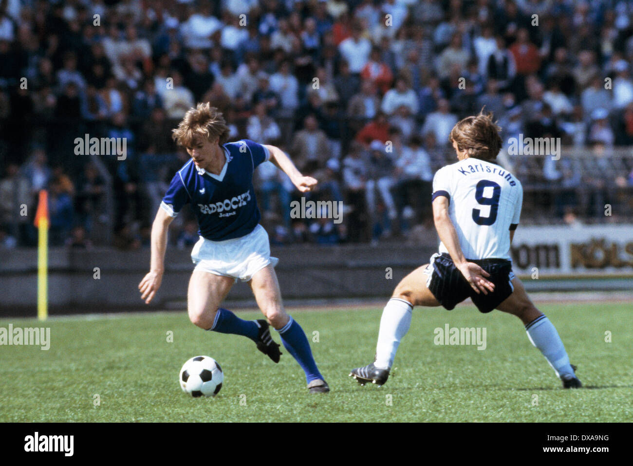 football, 2. Bundesliga, 1983/1984, Park Stadium, FC Schalke 04 versus  Karlsruher SC 3:3, scene of the match, Bernd Dierssen (S04) in ball  possession, right Emanuel Guenther (KSC Stock Photo - Alamy