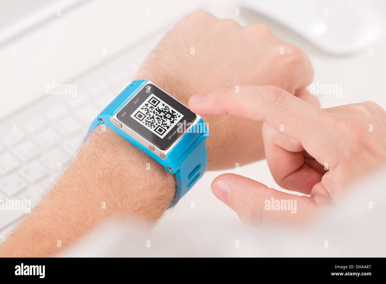 Man is scanning quick response code with blue smart watch Stock Photo
