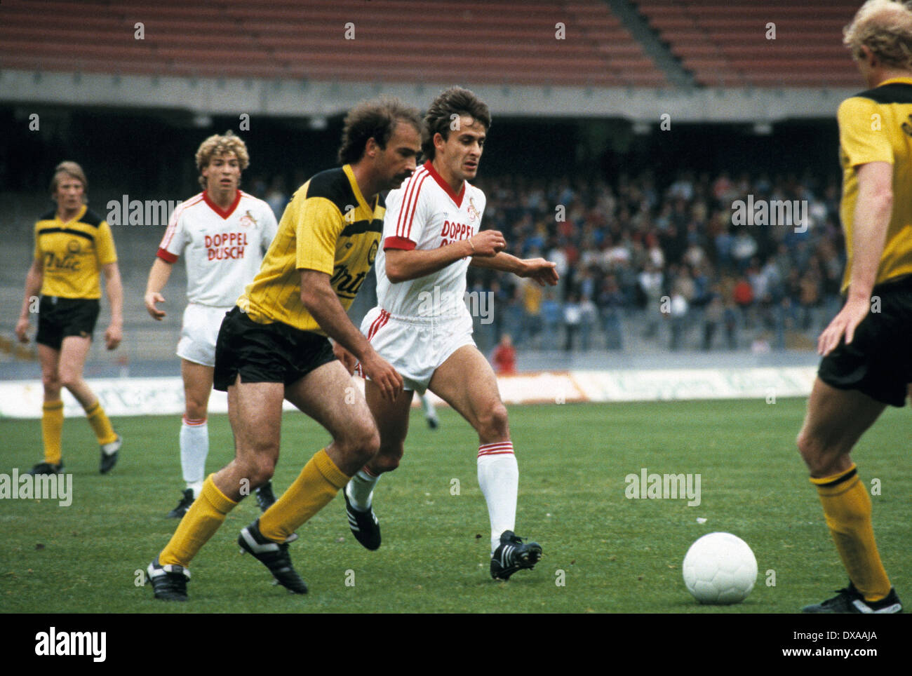 football, Bundesliga, 1983/1984, Muengersdorf Stadium, 1. FC Cologne versus Borussia Dortmund 5:2, scene of the match, f.l.t.r. Franz-Josef Tenhagen (BVB), Hans-Werner Reif (FCK), Harald Konopka (BVB), Pierre Littbarski (FCK) Stock Photo
