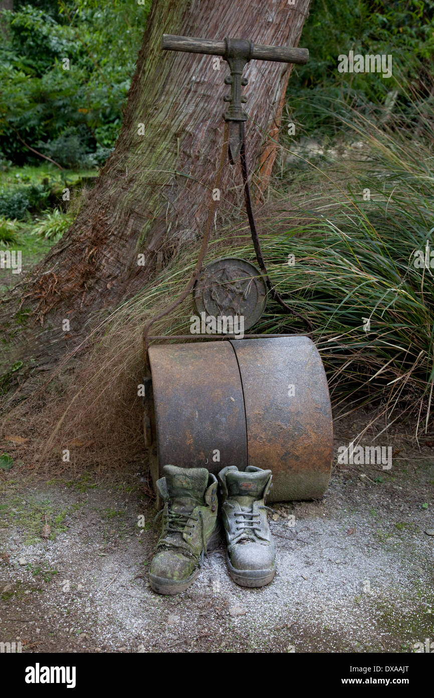 Garden roller and boots Lost Gardens of Heligan Cornwall UK Stock Photo
