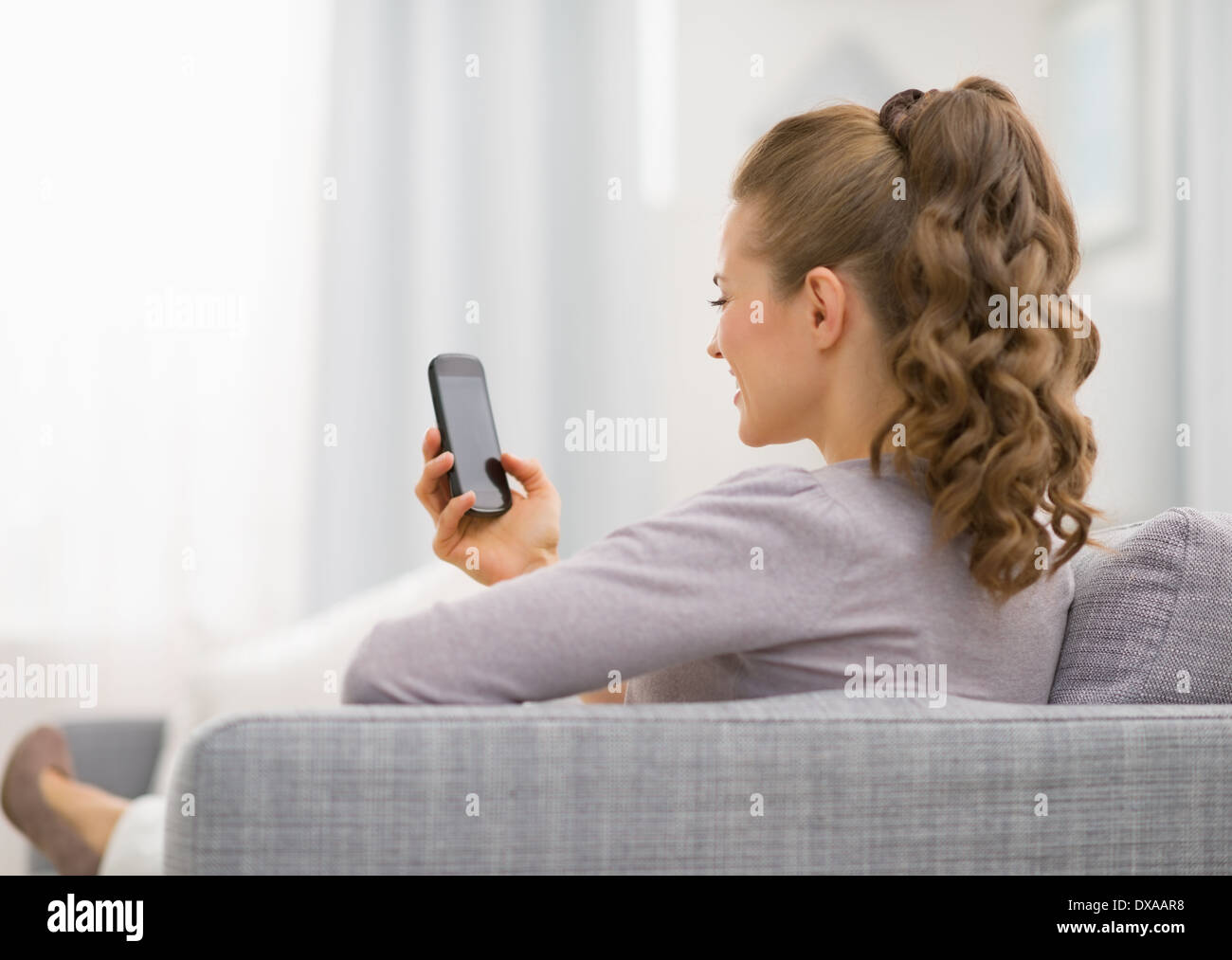 Woman reading phone rear view hi-res stock photography and images - Alamy