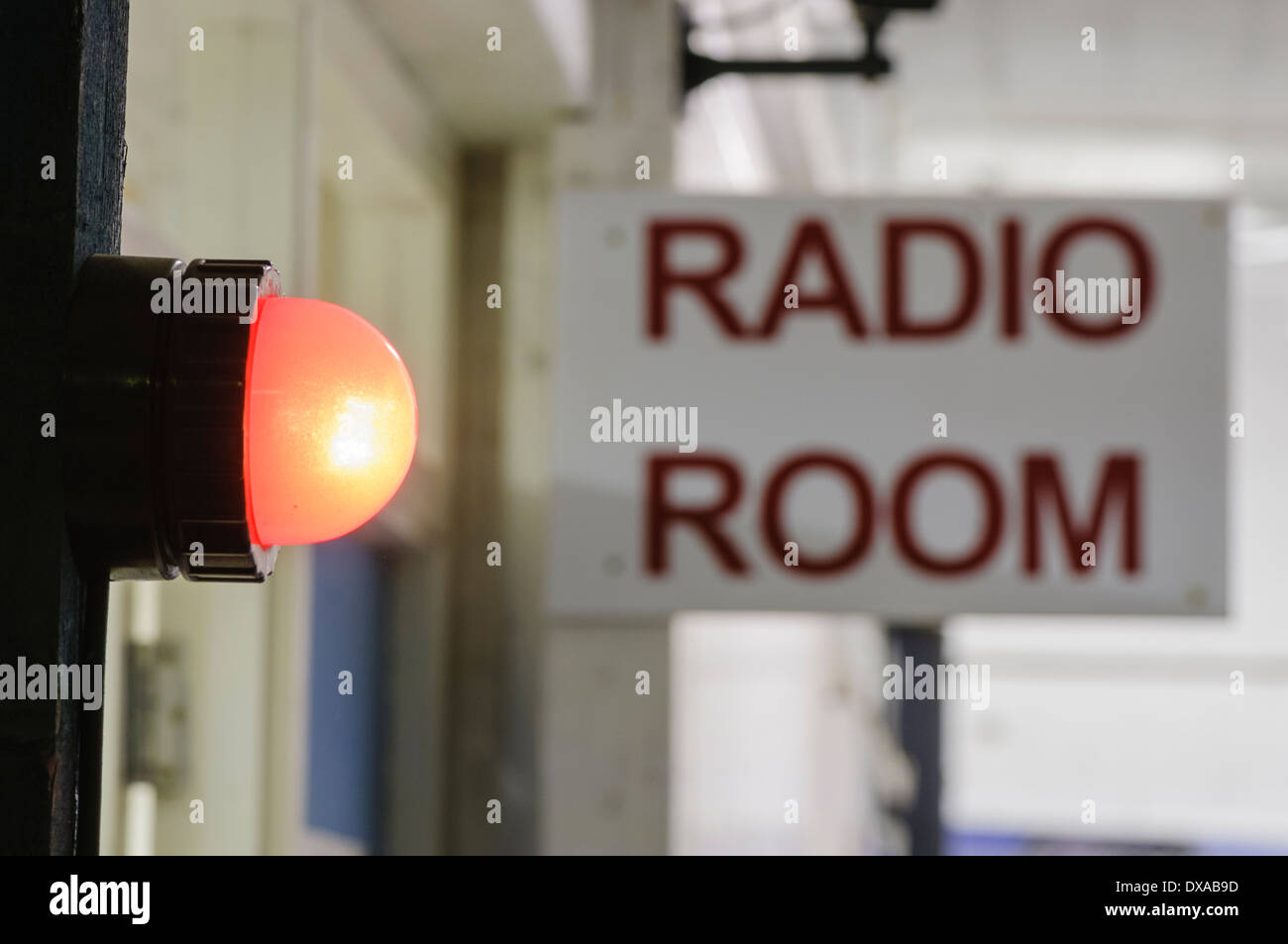 Red light illuminated outside a radio room to warn that transmissions are in progress Stock Photo