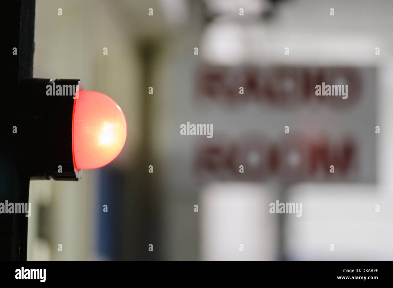 Red light illuminated outside a radio room to warn that transmissions are in progress Stock Photo