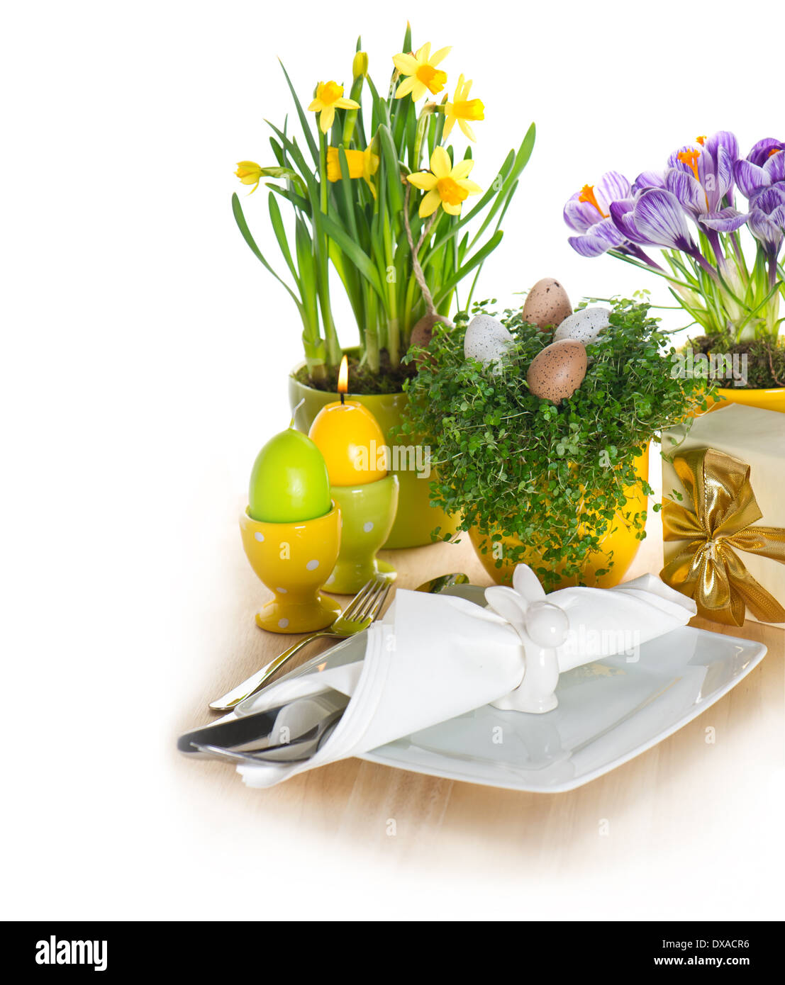 festive easter table setting with eggs and flowers decoration on white background Stock Photo