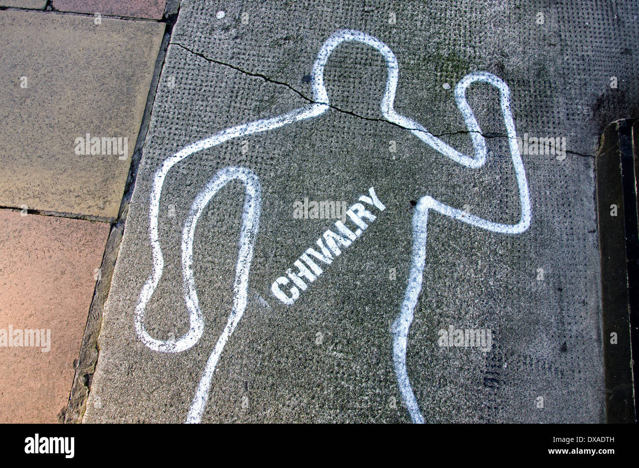 Chivalry is dead - the outline of a body and the word 'chivalry' drawn on the pavement. Stock Photo