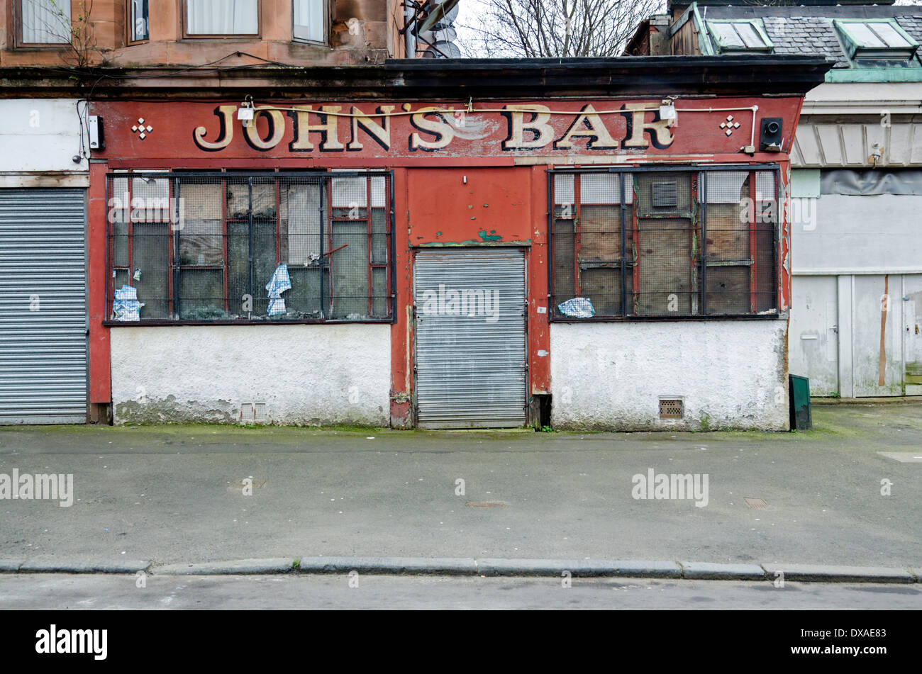John's Bar, a derelict public house in Tobago Street in the Calton area of Glasgow. Stock Photo